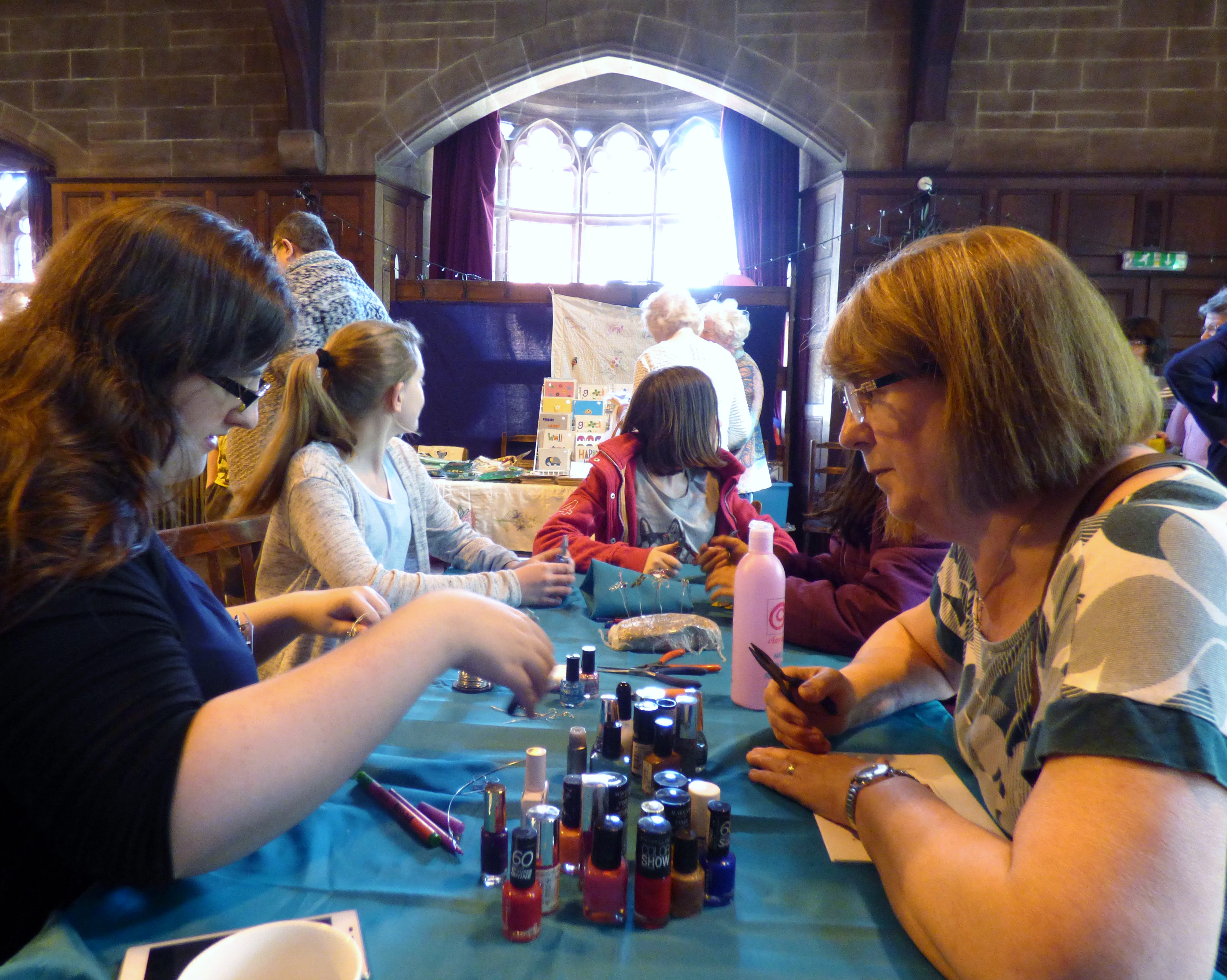 Sophie is demonstrating how to make wire butterflies at MEG Summer Tea Party 2016