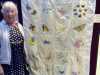 Rubina Porter MBE with butterfly silk embroidered quilt made by mothers and girls of Sreepur, with help from members of MEG, at 60 Glorious Years exhibition in Liverpool Cathedral 2016.