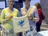 Kim Parkman and Cllr. Roz Gladden, Lord Mayor of Liverpool with MEG cotton bag made in Sreepur at 60 Glorious Years exhibition in Liverpool Cathedral