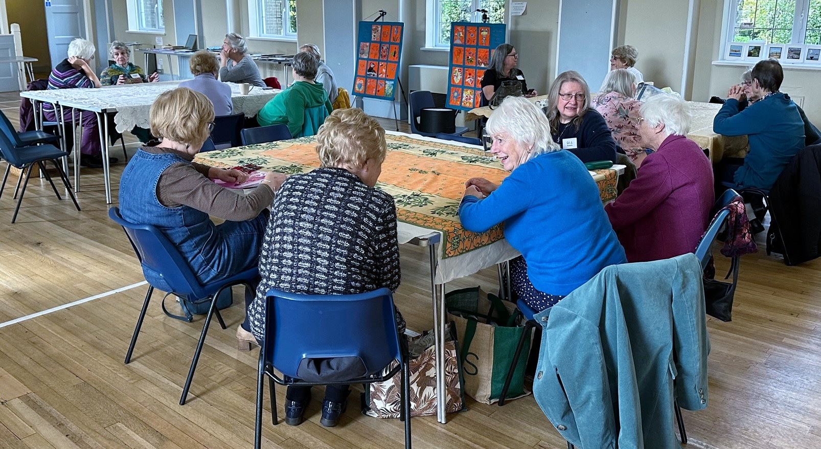 members of Merseyside Expressive Stitchers' Group chatting at October 2023 meeting