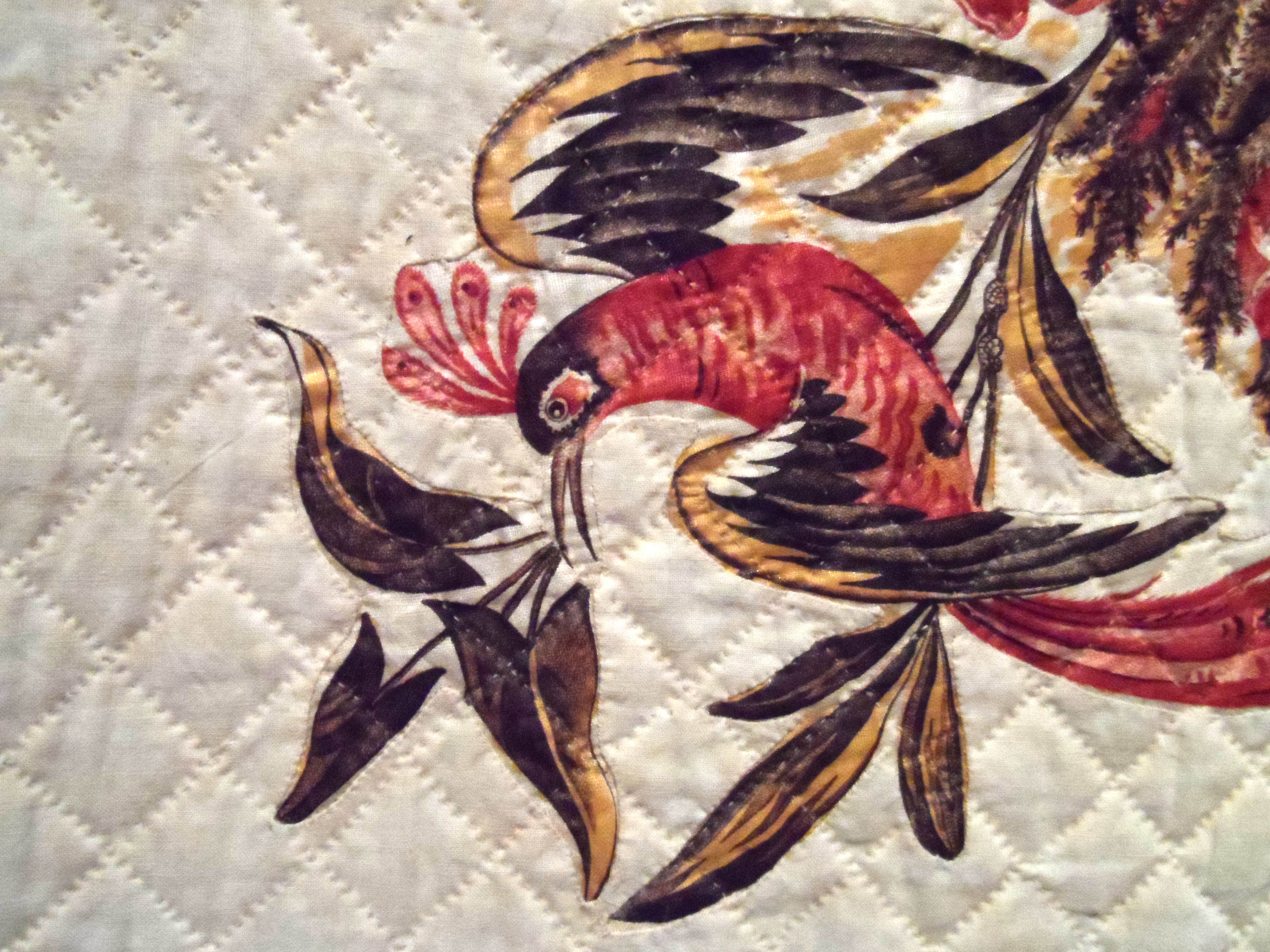 detail of MEDALLION QUILT, circa 1830, cotton, reverse applique technique used. The ground fabric is cut away from the decorative elements that lie below.
