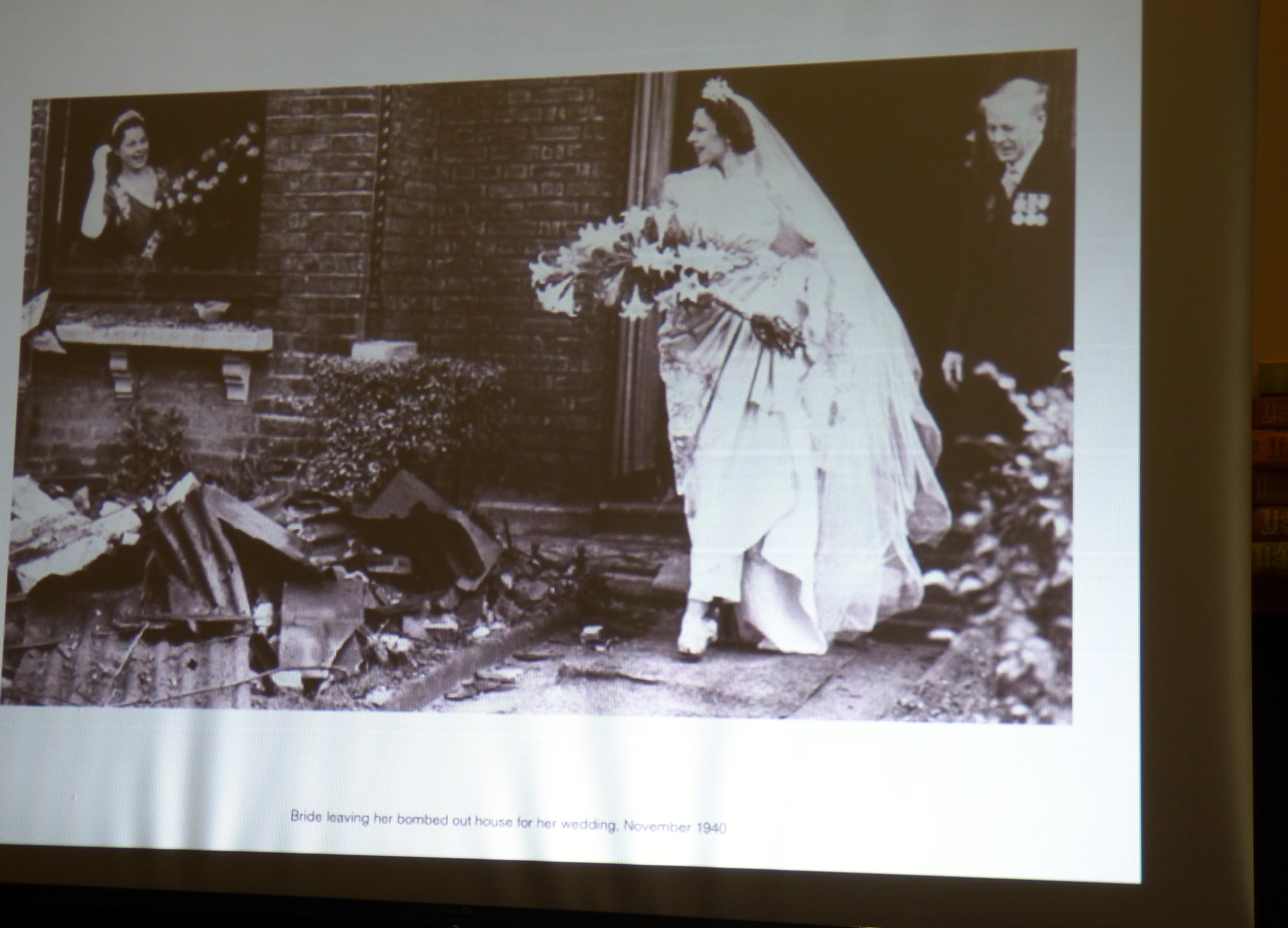 slide showing a bride leaving her bombed out house gor her wedding, November 1940