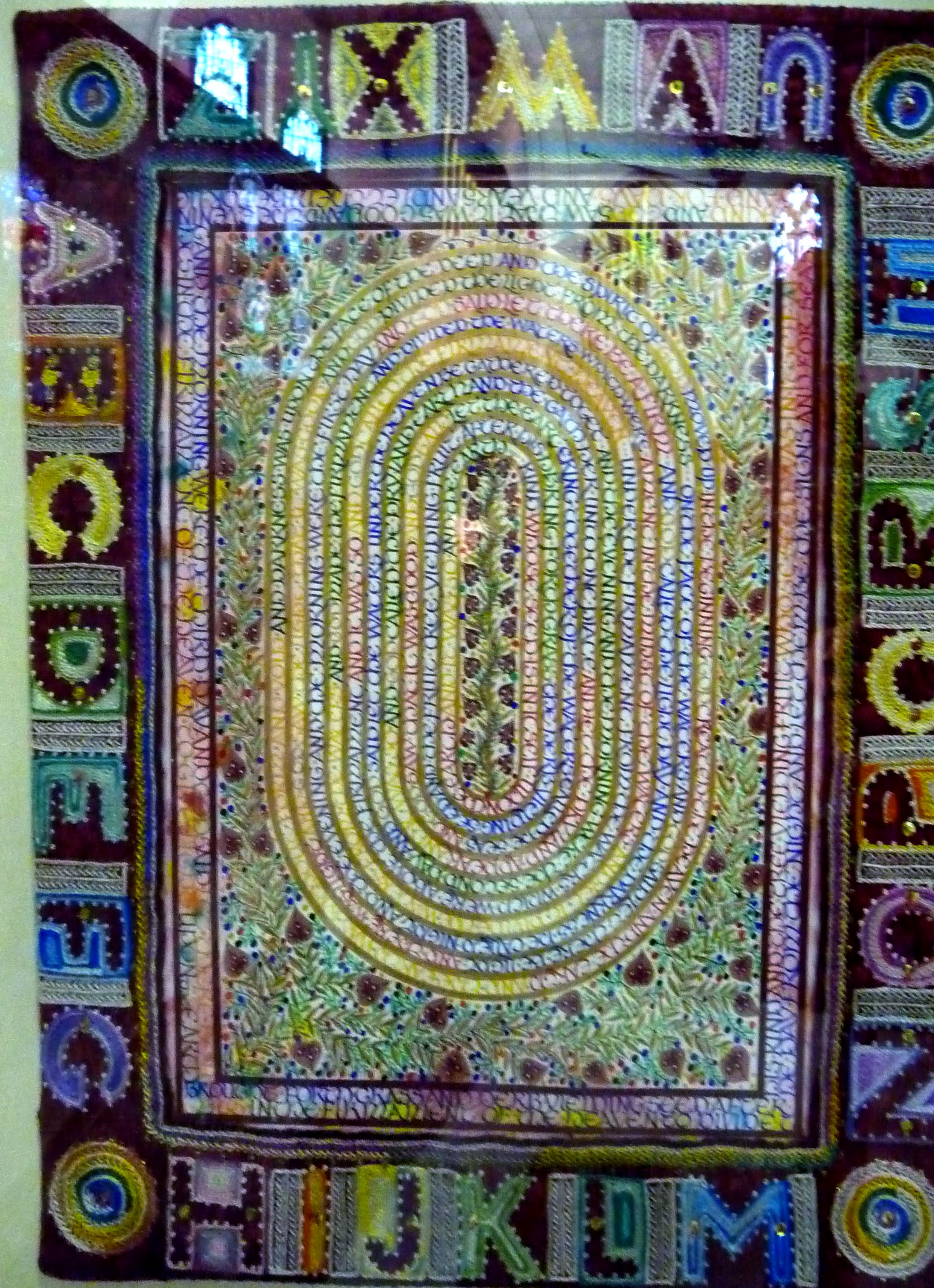 CREATION: A CELEBRATION by Sue Symonds, CARPET PAGE: LANGUAGE , painting with embroidered frame