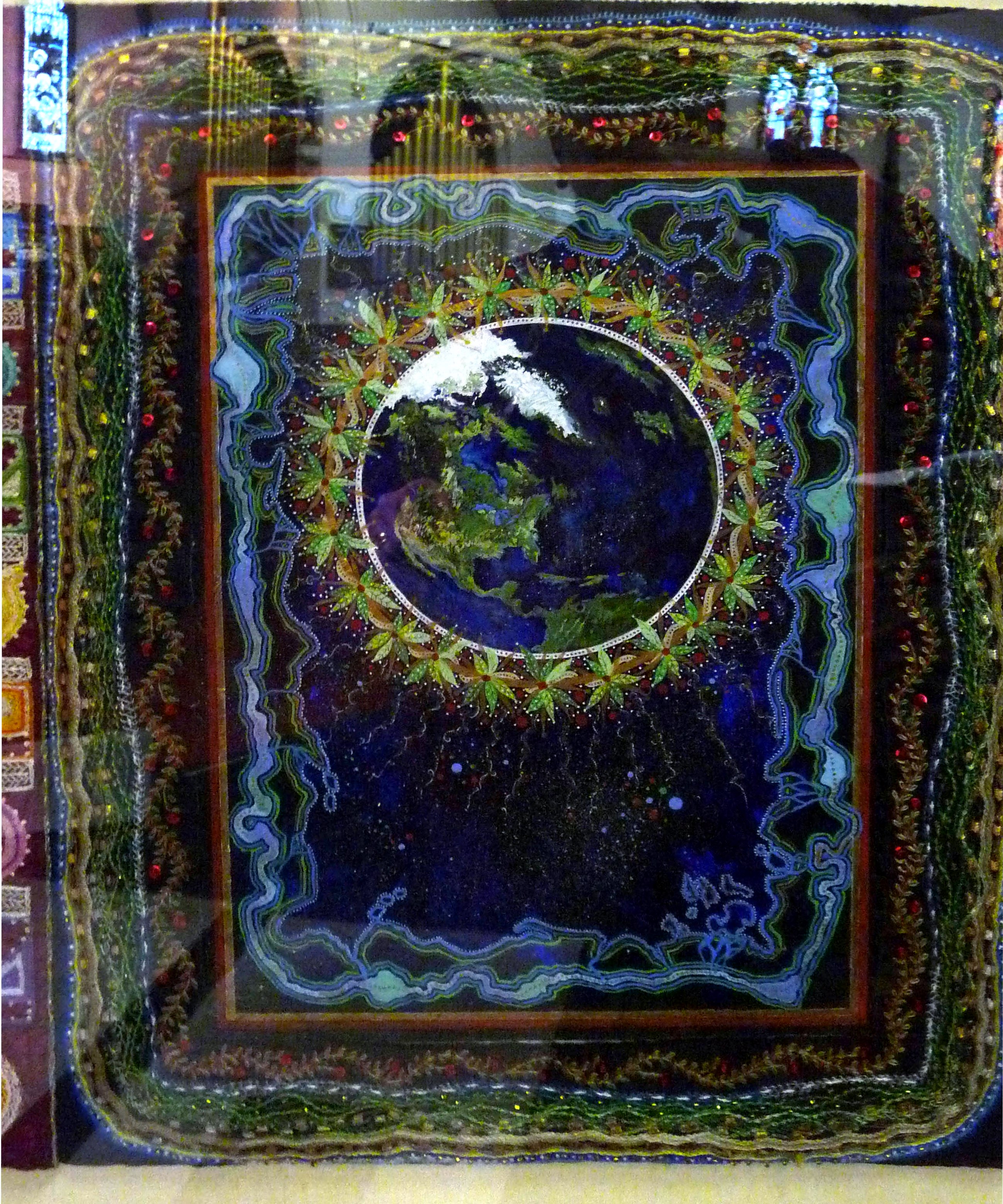 CREATION: A CELEBRATION by Sue Symonds, CARPET PAGE: EARTH FROM SPACE , painting with embroidered frame