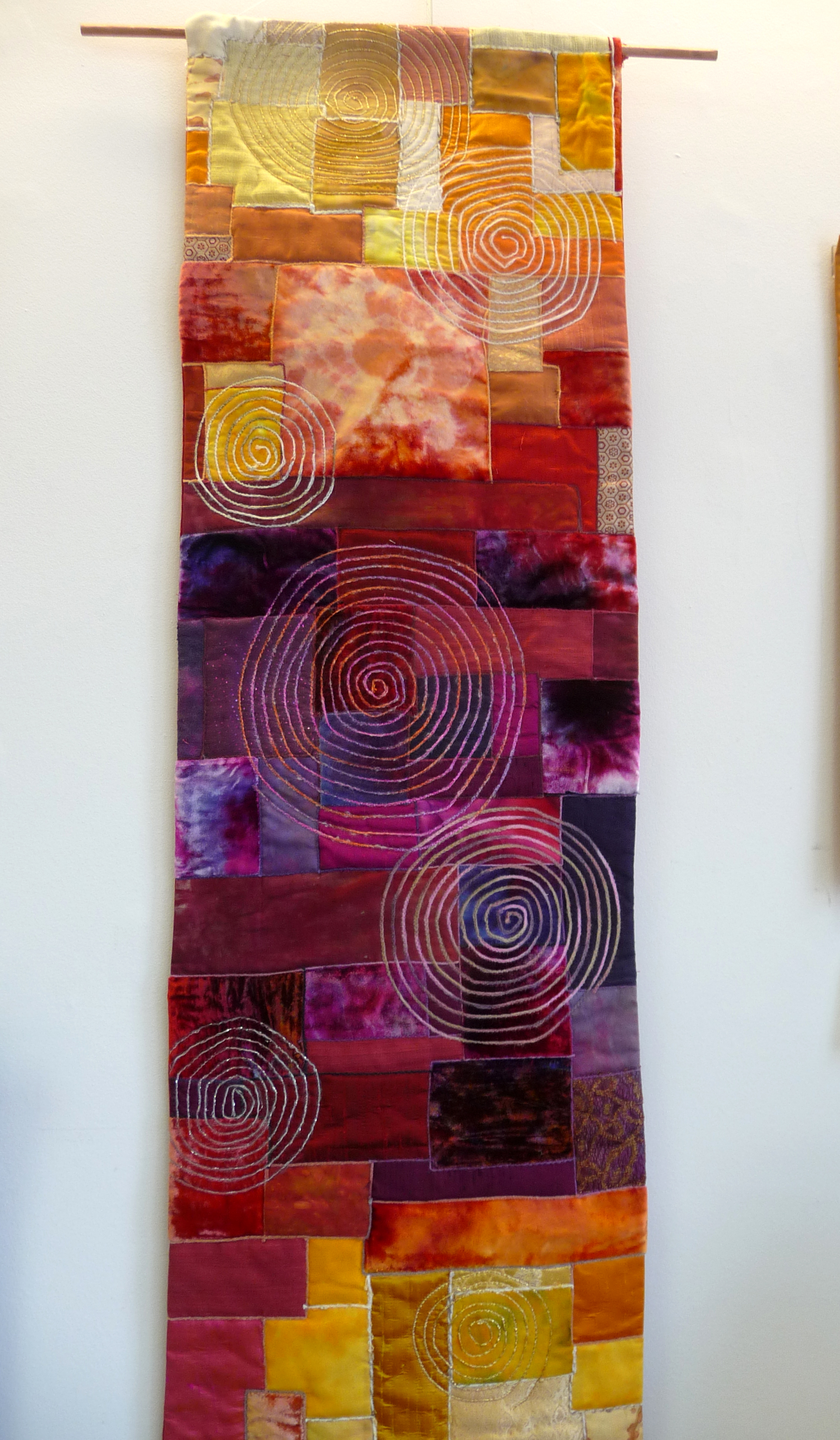 RED HOT SPIRAL GALAXY by Eileen Norris, quilted wall hanging