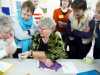 Sue Hinde explaining a Goldwork technique to the group