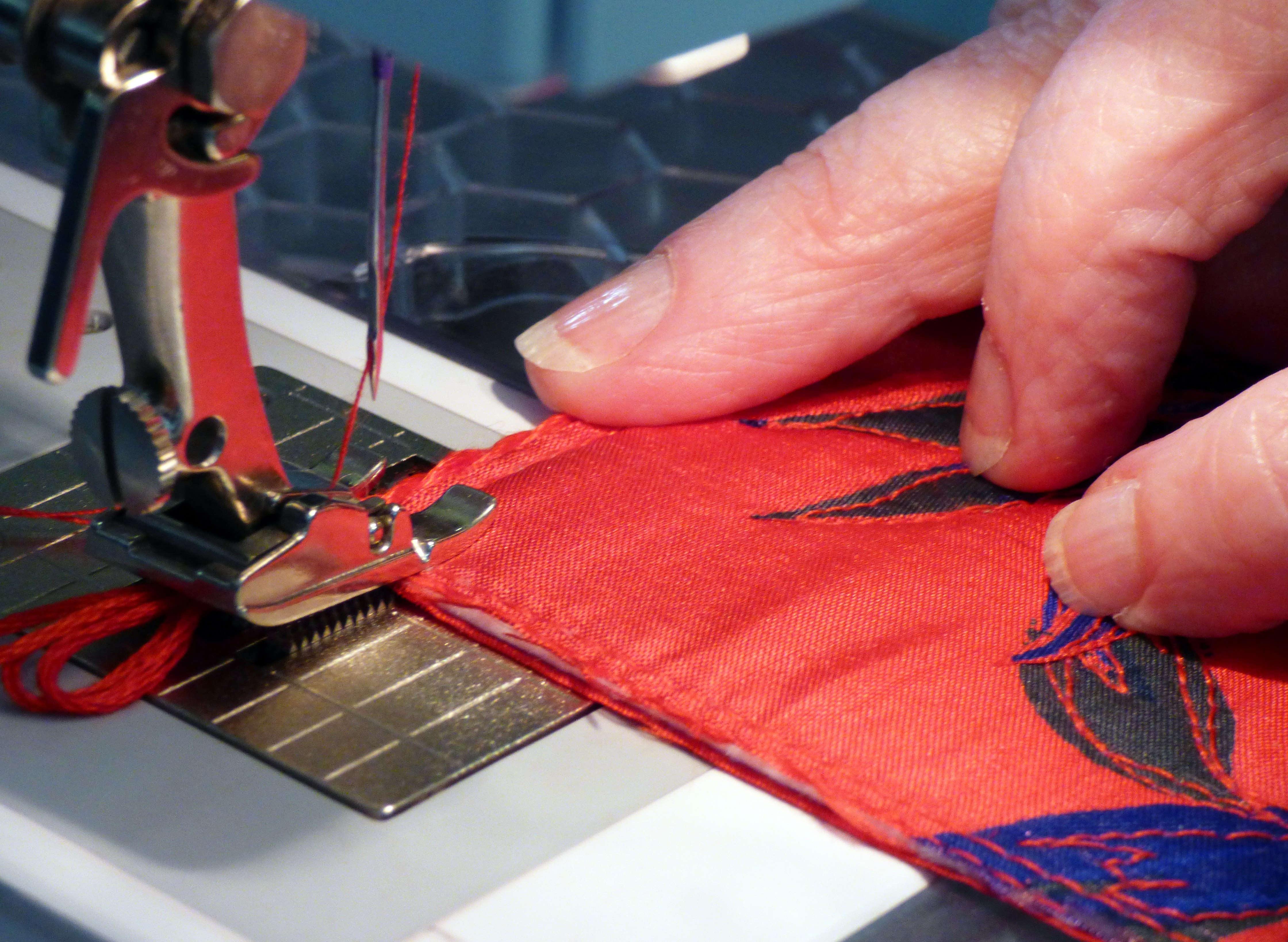 Sheila Conchie demonstrating how to attach the cord trim at 5 sided casket workshop, July 2019