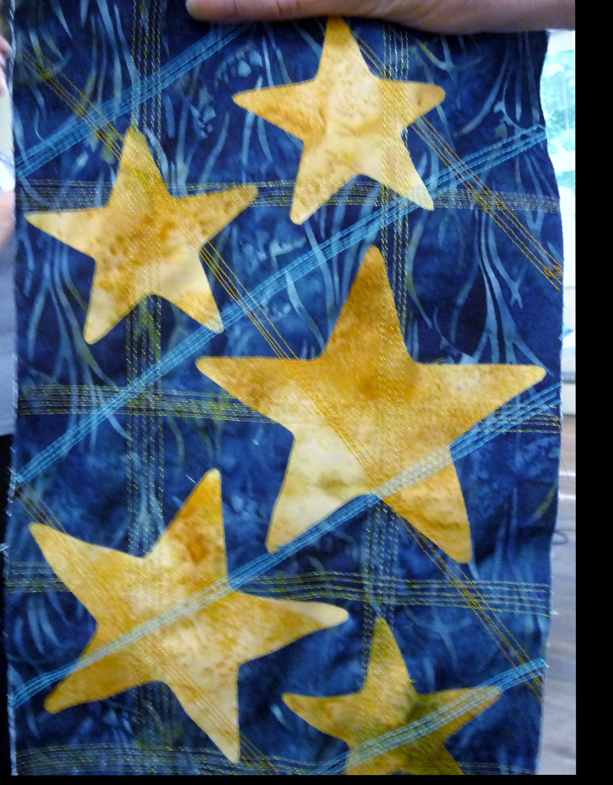 sample of applique with added machine stitching by Norma Heron