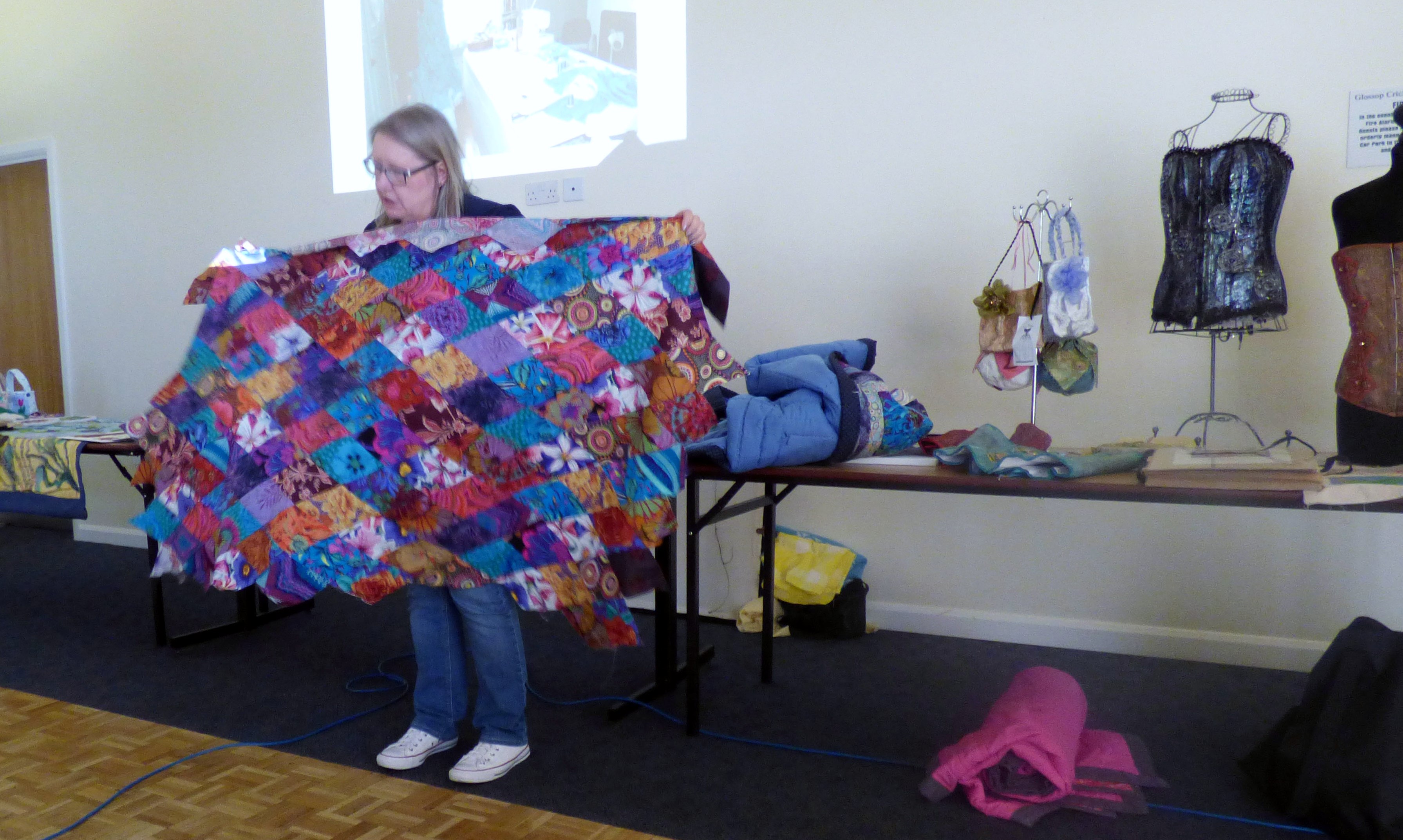 Gill Roberts showing Glossop EG a quilt top she made following a Kaffe Fassett workshop