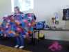Gill Roberts showing Glossop EG a quilt top she made following a Kaffe Fassett workshop