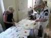 Ruby is showing some of our visitors her hand embroidered quilts