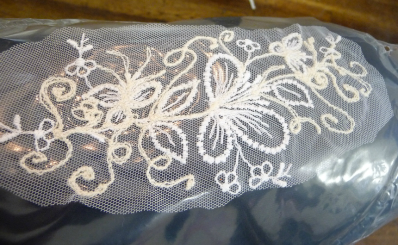 a scrap of lace and soluble backing further embellished with machine embroidery