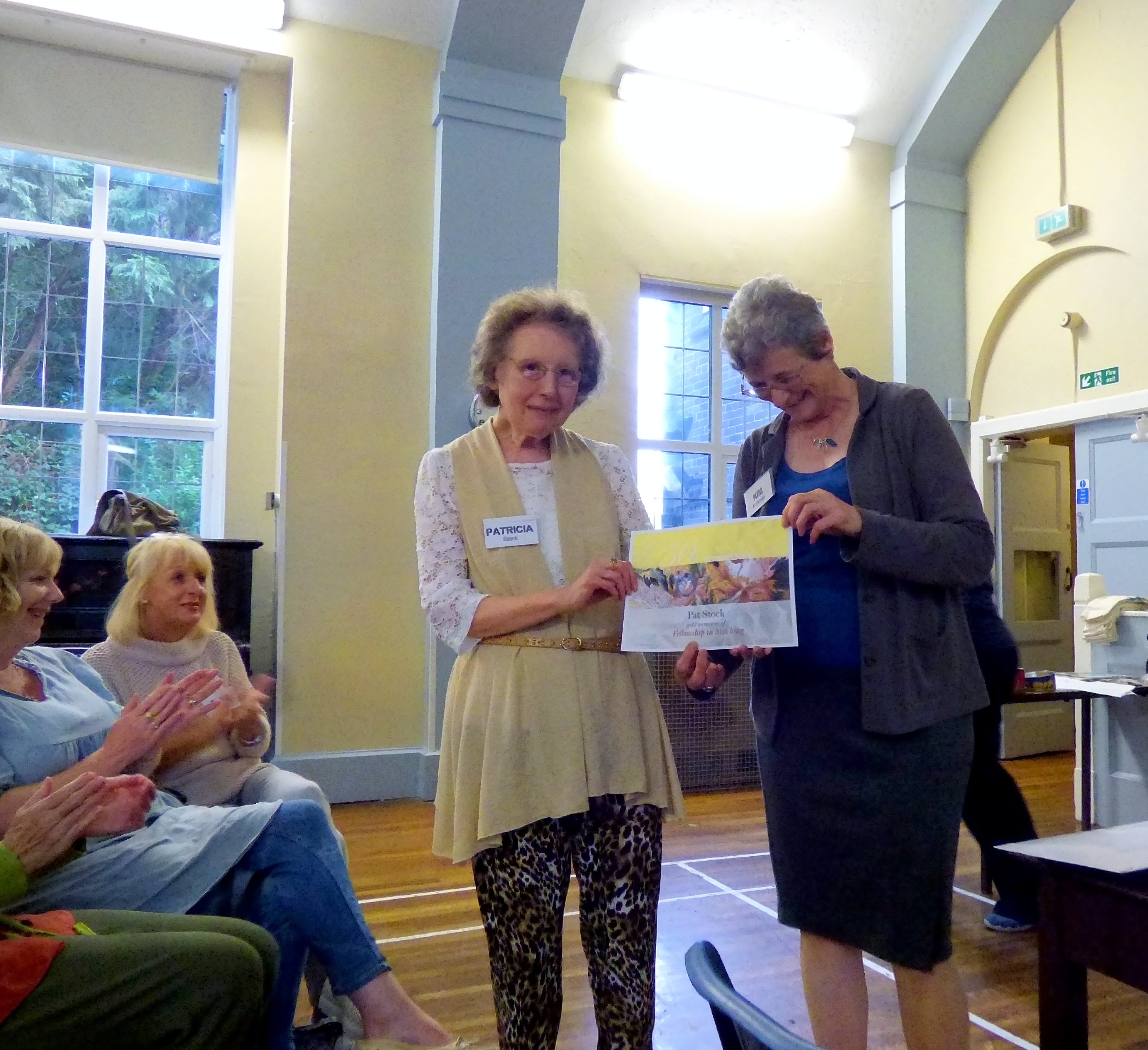 Pat Stock is presented by Kim Parkman with her certificate to celebrate 50 years as a member of Embroiderers' Guild