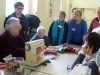 Richard Box is demonstrating how to stitch the poppy collage