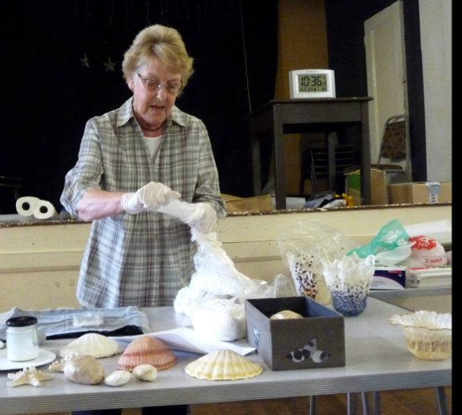 Linda Rudkin is demonstrating how to separate the fibres of mulberry silk