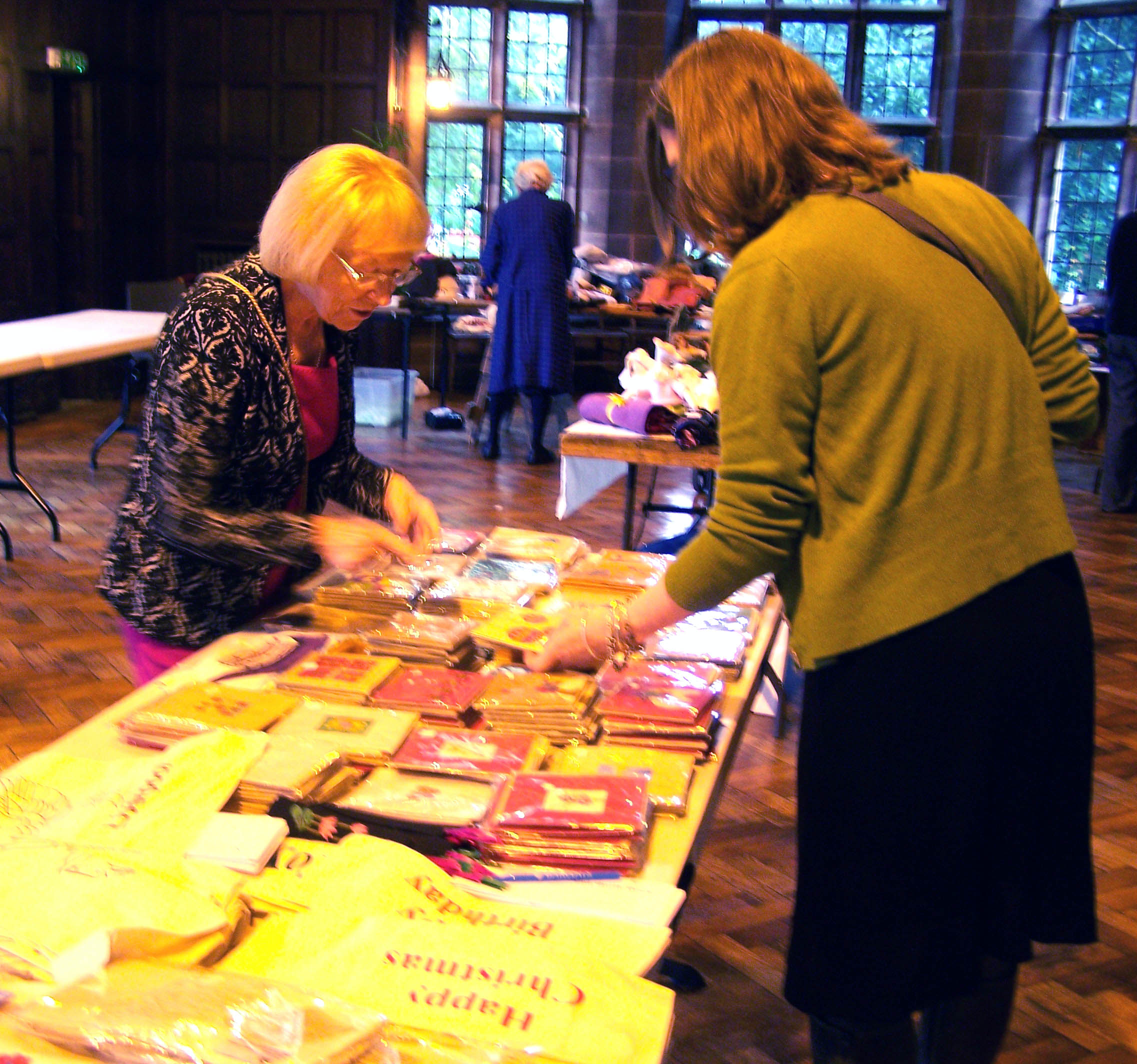 Kathy and Karen are preparing the Sreepur Charity table