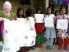 Ruby in Sreepur Village, Bangladesh with the flower quilt and some of young embroiderers who made the squares for the quilt which was jointly completed with Merseyside Young Embroiderers