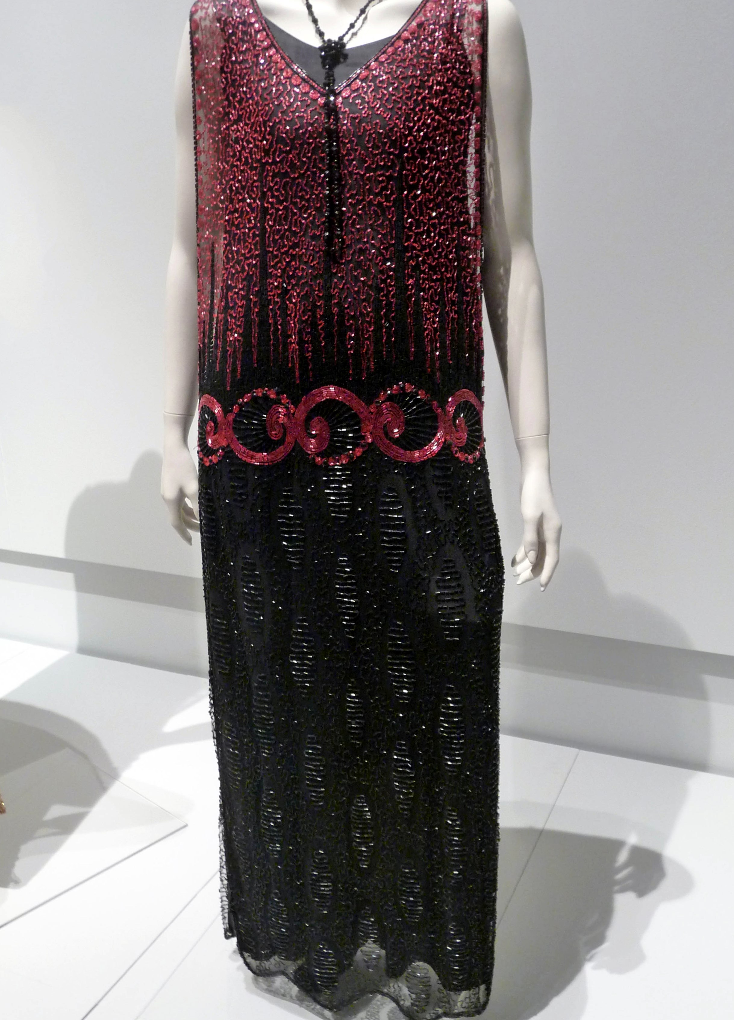 TUNIC-STYLE EVENING DRESS, silk net embroidered with glass bugle beads, rayon silk under-slip, circa 1921-23.