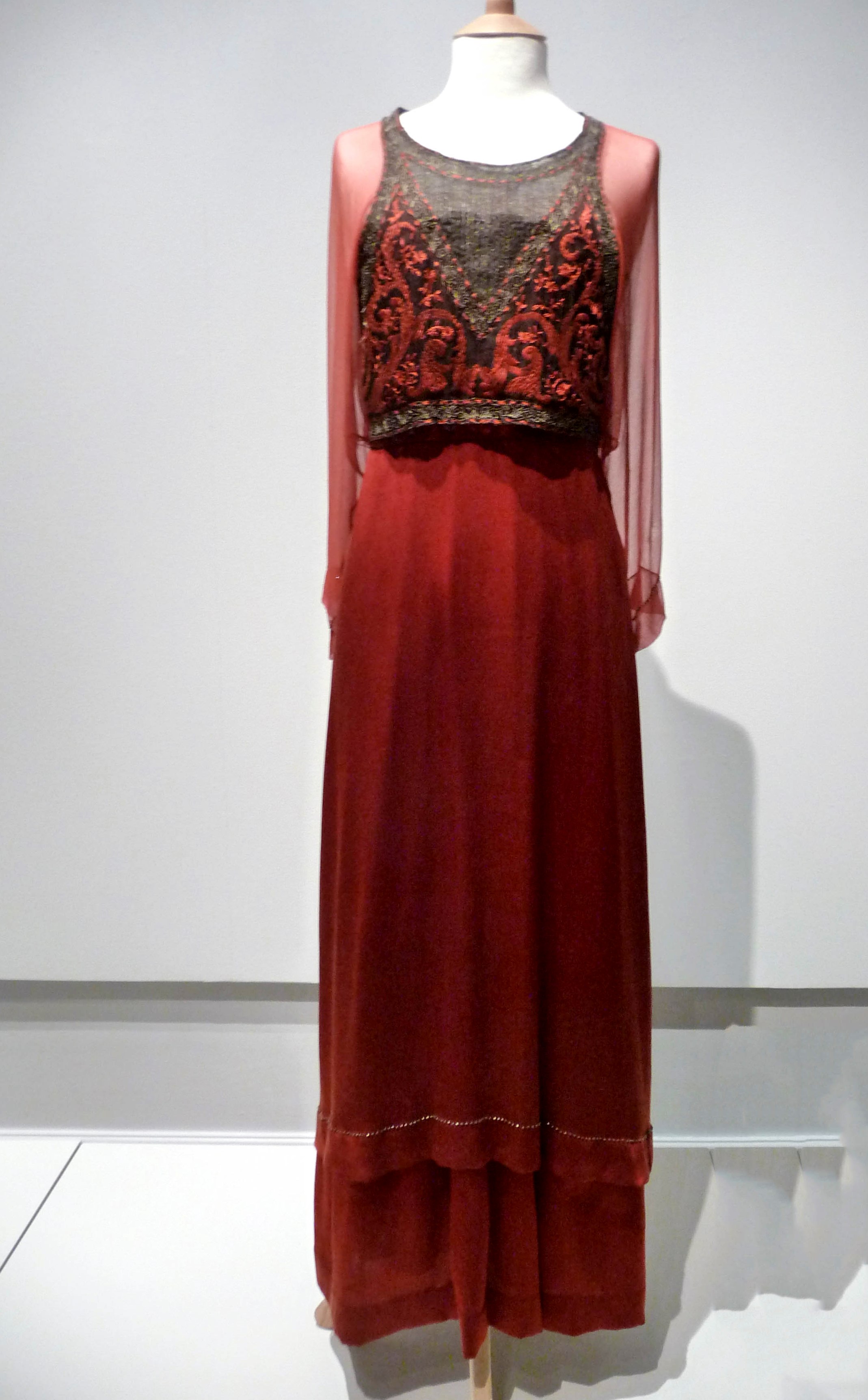 EVENING GOWN, silk and silk chiffon, with applied silk folk motifs, made by Cosprop, 2010. Worn by Michelle Dockery as Lady Mary Crawley in Downton Abbey.