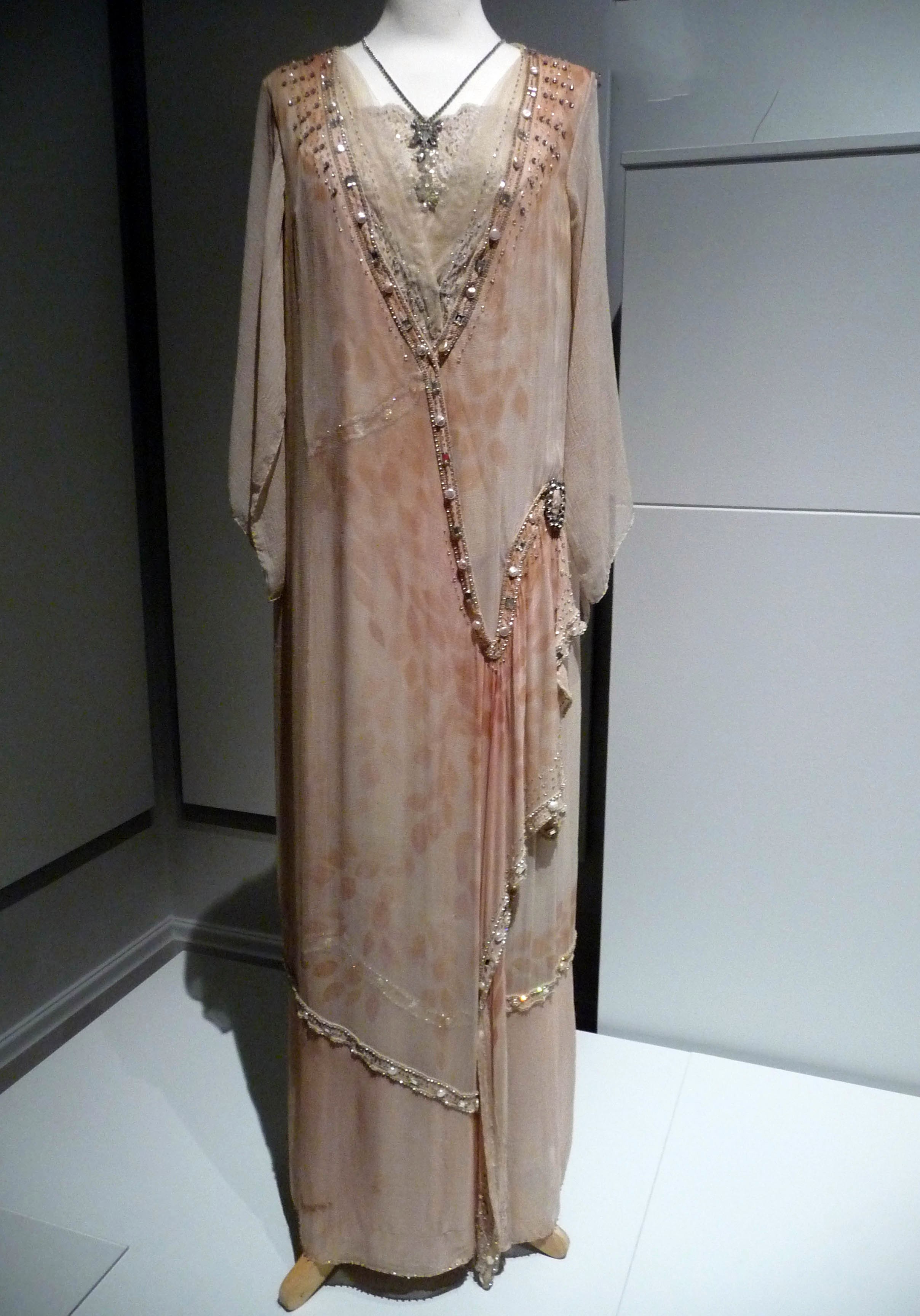 TUNIC-STYLE EVENING DRESS, printed crepe with diamante, pearl and mirrored glass beading, made by Cosprop, 2012. Worn by Elizabeth McGovern as Cora Crawley, th Countess of Grantham in Downton Abbey.