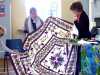 Margaret Smith with a quilt she made and hand quilted