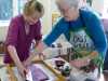 Elsie is showing Sarah how to print her fabric