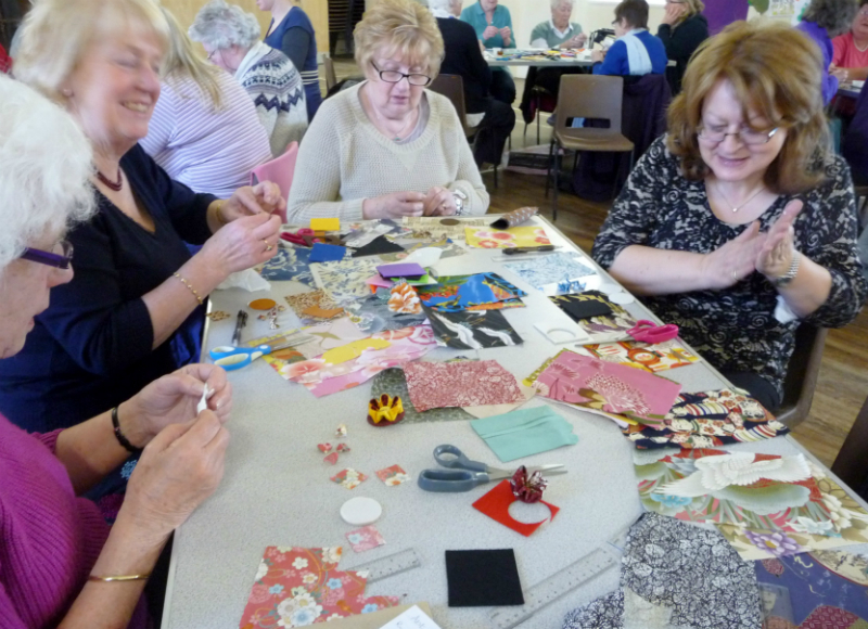 the group are having an enjoyable time making Japanese Kanzashi flower brooches