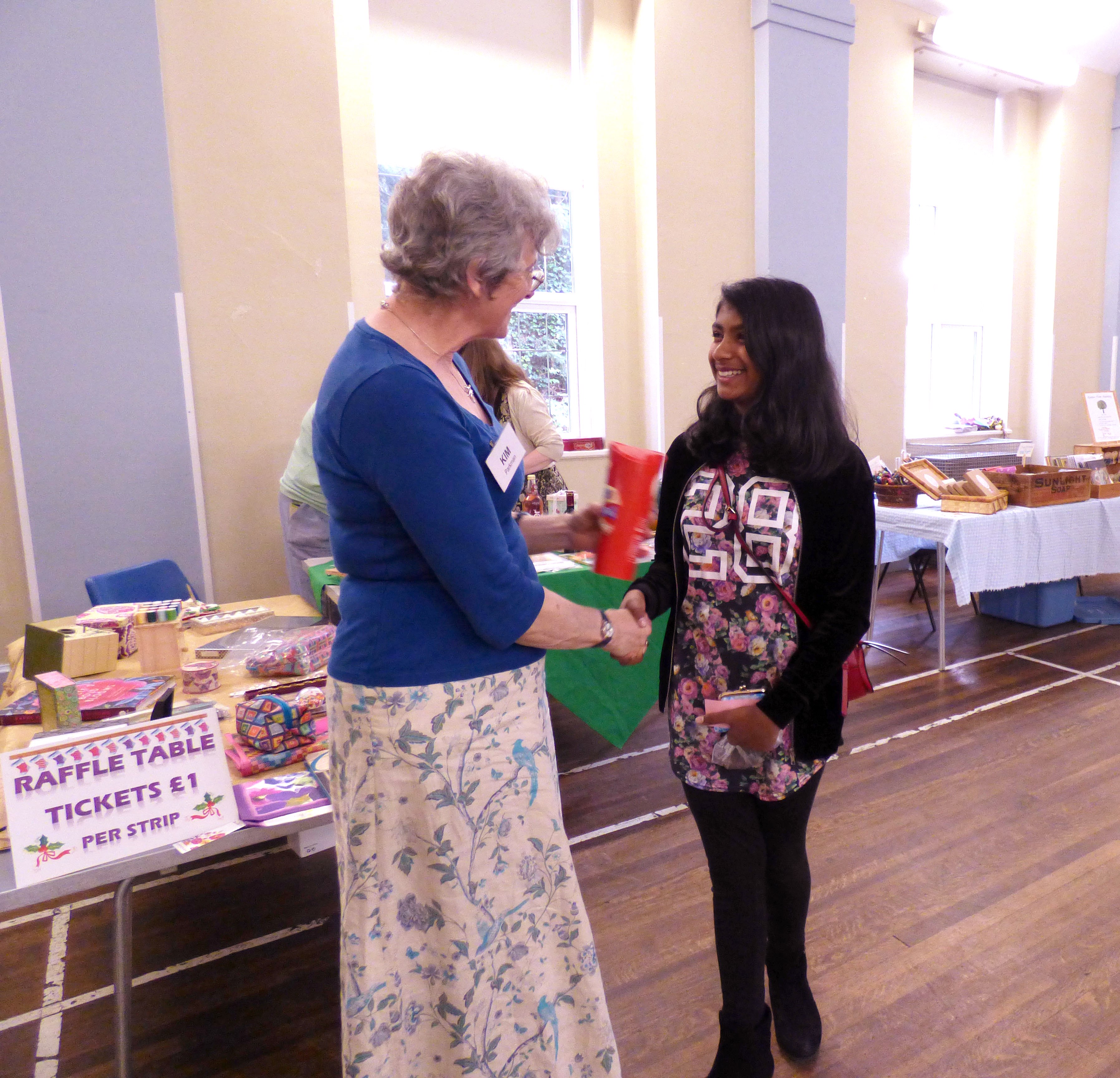 Grace is receiving a prize for her cushion embroidery at  MEG Summer Party 2017