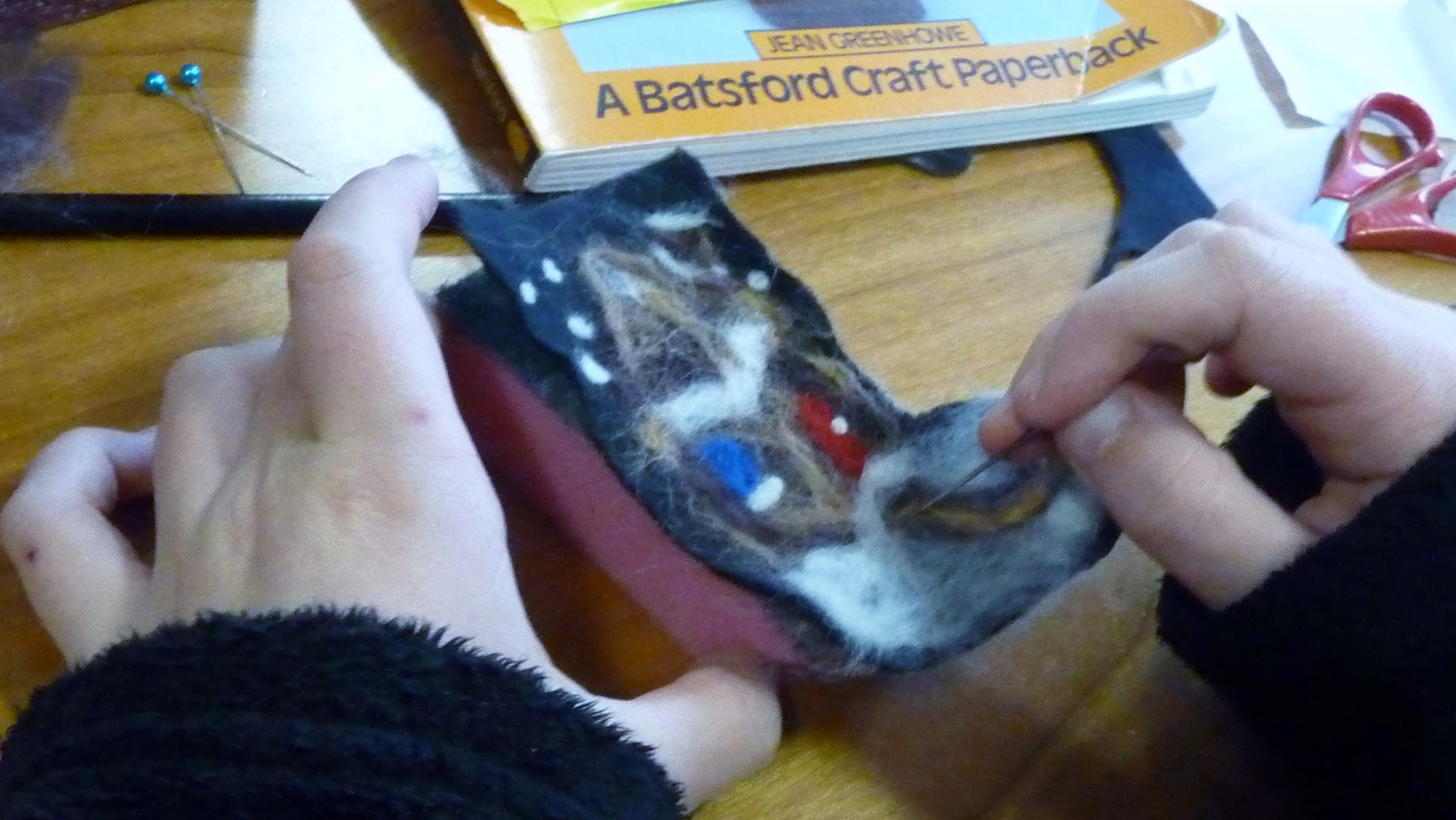 Chloe has needle-felted a log cabin on her Christmas stocking