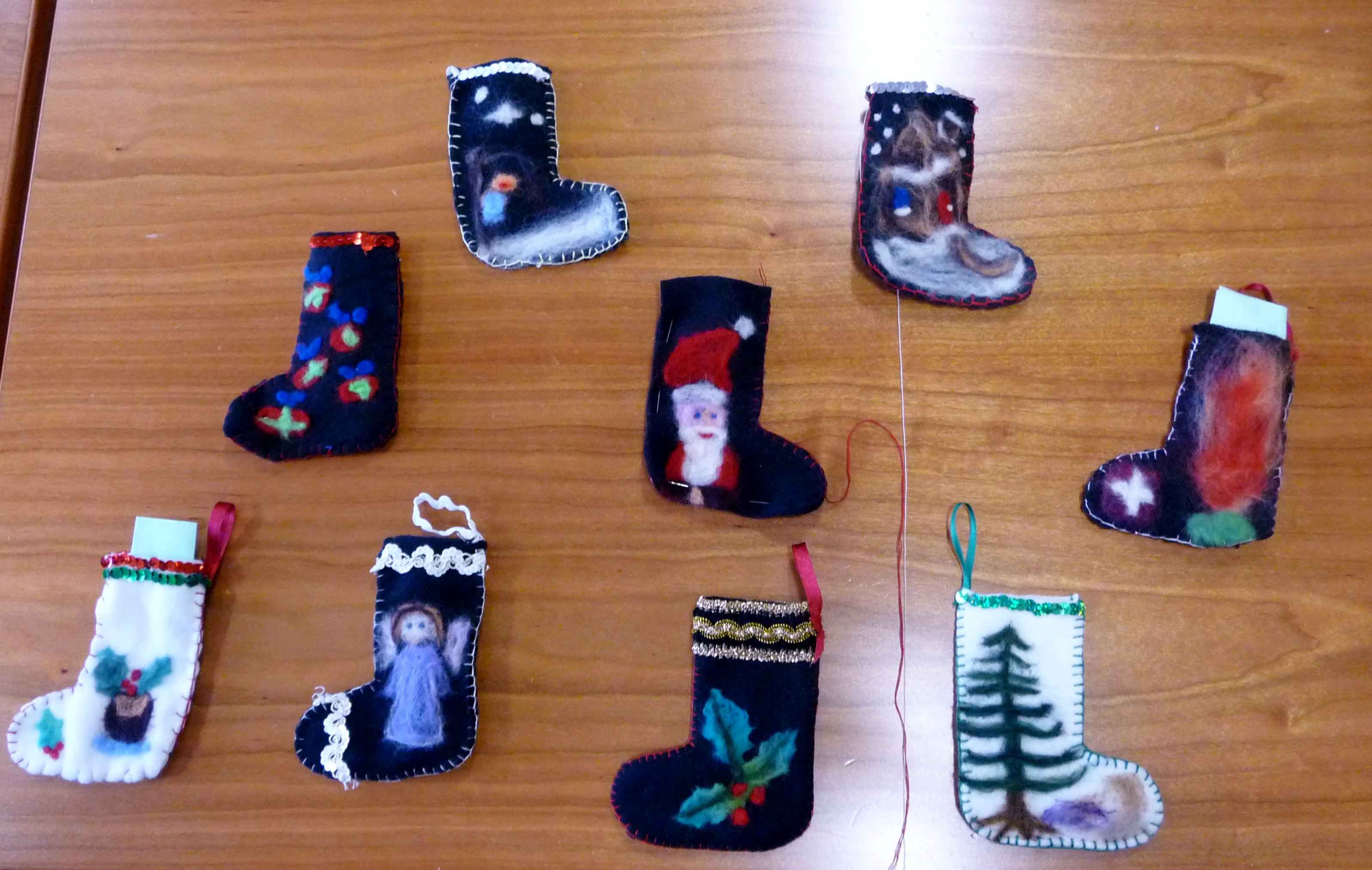 a collection of needle-felted Christmas stockings made by Merseyside YE group