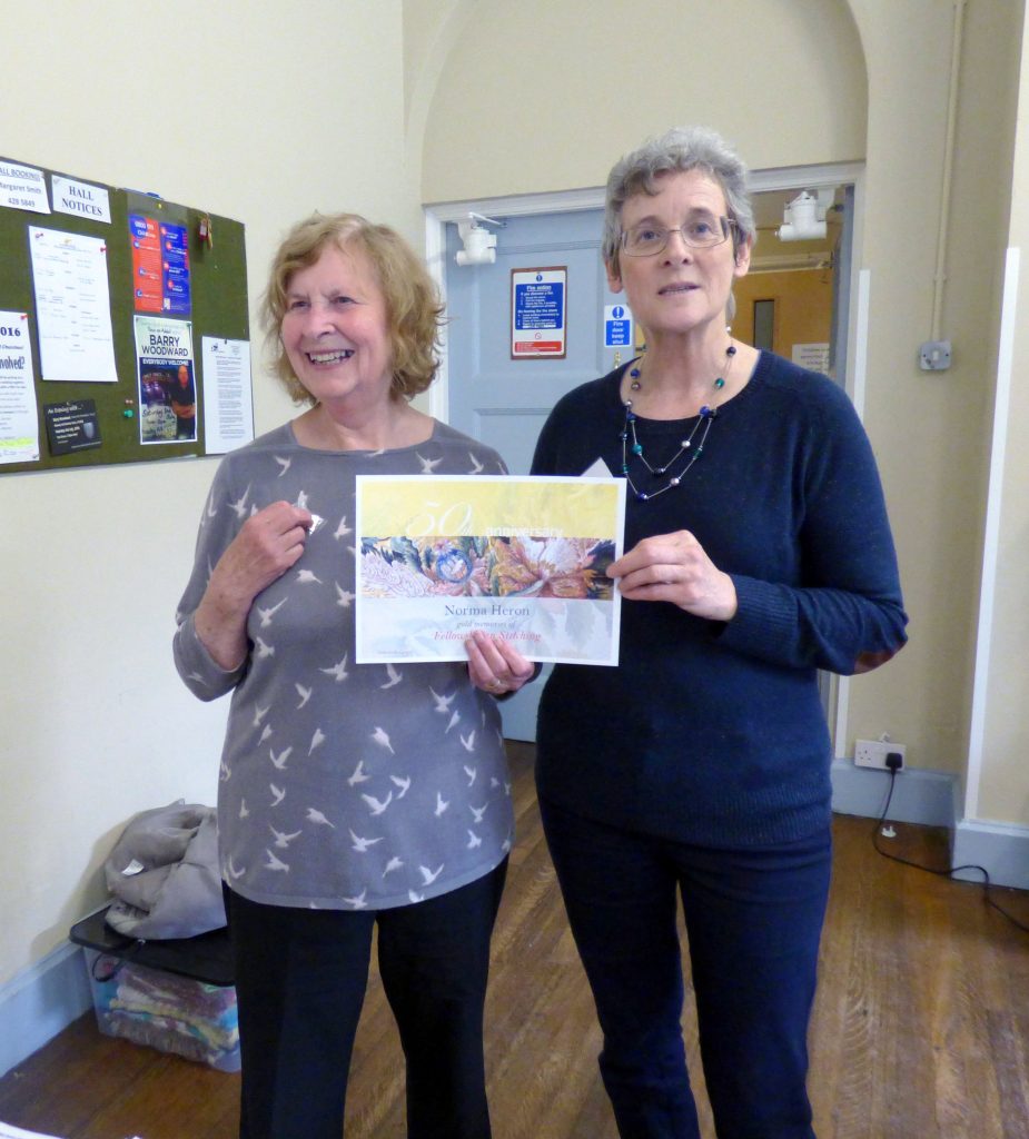 Norma Heron is presented with her 5o year gold badge by MEG Chair Kim Parkman
