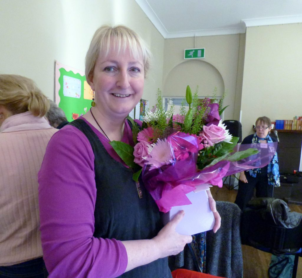 Sarah was presented with a beautiful flower arrangement as she left the committee after 12 years of service, October 2016